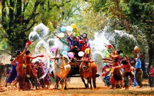 People throwing water at each other to welcome the new year